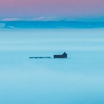 Frozen lake under a pink sky